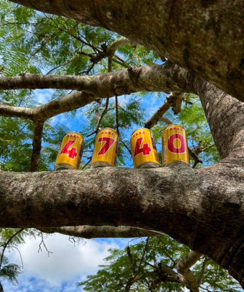 XXXX cans that say "4740" on the branch of a tree